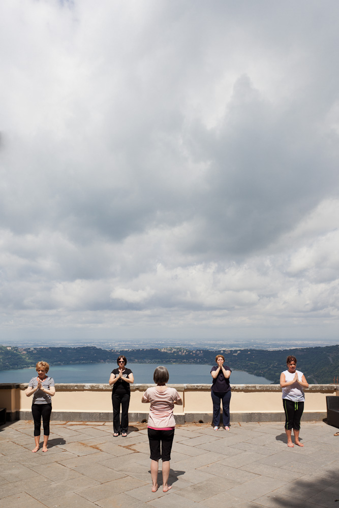 Rose and the class practicing yoga on the sun deck of the Italan Villa amidst beautiful scenery